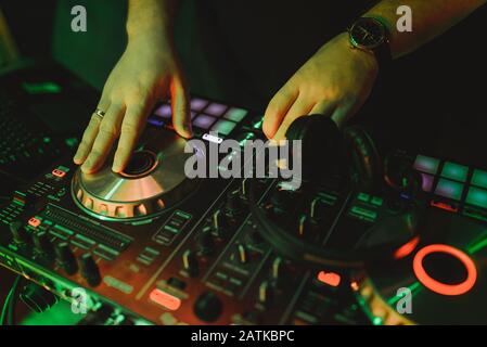 Dj mixes the track in the nightclub at a party Stock Photo