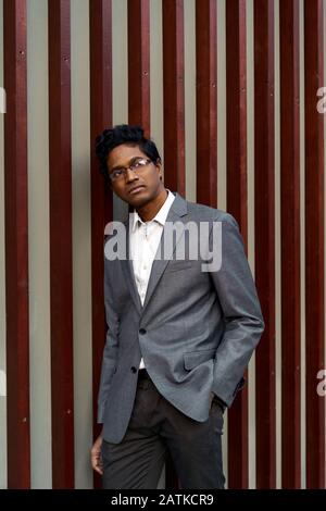 Handsome young mixed race man looking over his glasses.  Stock Photo