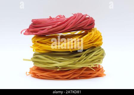 Isolated colored spaghetti nests on a white background. Stock Photo