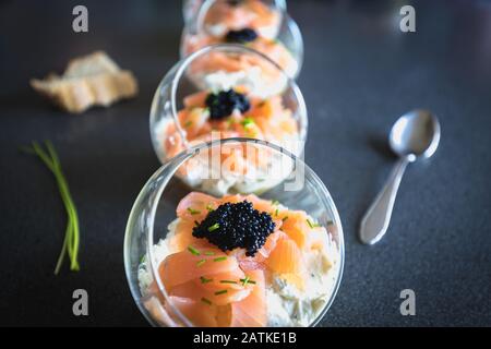 verrine salmon lumpfish egg fresh cheese and avocado bed in the kitchen Stock Photo