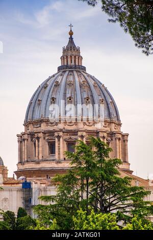 Rome, Vatican City / Italy - 2019/06/15: Panoramic view of St. Peter’s Basilica - Basilica di San Pietro in Vaticano - dome by Michelangelo Buonarotti Stock Photo