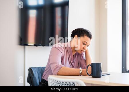Serious young businesswoman using graphics tablet in office Stock Photo