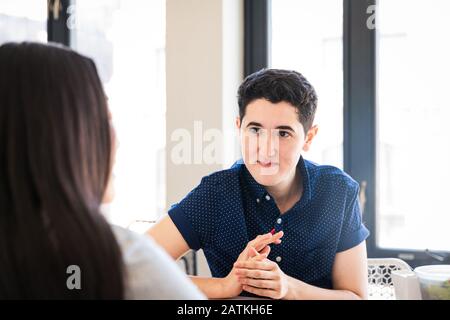 businessman discussing with female coworker in office Stock Photo