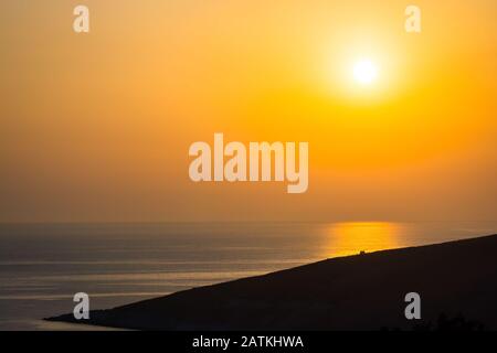 Orange sunset near Dhermi in Albania Stock Photo