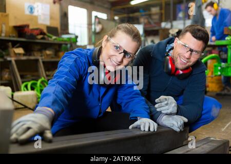 happy man and woman in factory Stock Photo