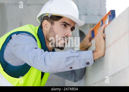 man builder measures the level of a wall Stock Photo