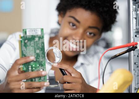 female engineer testing circuit board Stock Photo