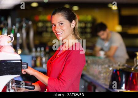 portrait of waitress using coffee machien Stock Photo