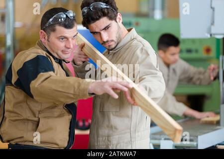 portrait of carpenter measuring wood Stock Photo