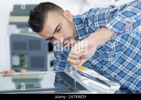 man fixing cartridge in printer machine at office Stock Photo