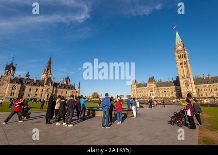 OTTAWA, CANADA - October 9, 2019: Tourists taking pictures in front of Canadian Parliament in Ottawa. Stock Photo