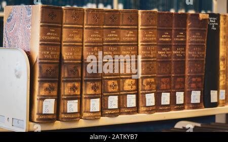 a collection of cyclopedia books placed on a library shelf Stock Photo