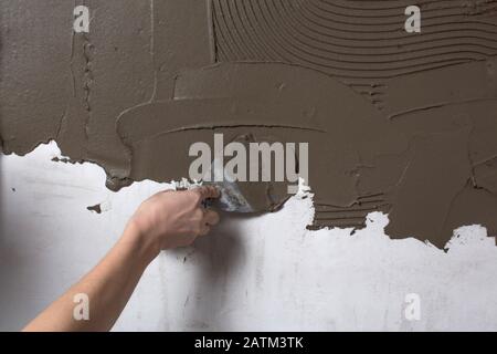 Construction Worker Applying Cement Plaster Coating On The Ceiling
