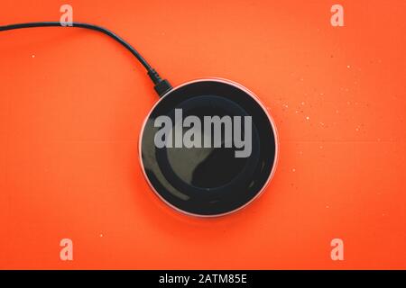 Wireless Charger orange background Top view Stock Photo