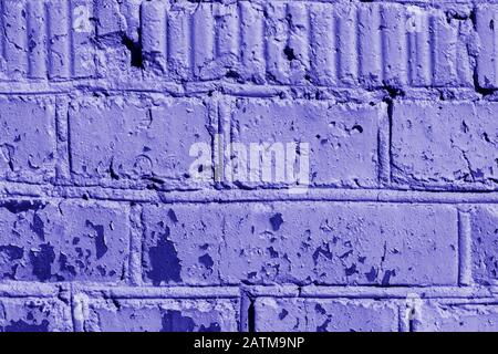 Old painted brick wall close-up. Brick wall background blue color toned Stock Photo