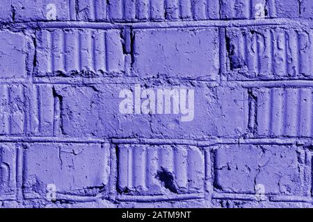 Old painted brick wall close-up. Brick wall background blue color toned Stock Photo