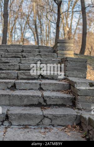 Old stairs in the park. Ruined concrete stairs.  Destroyed path. Stock Photo