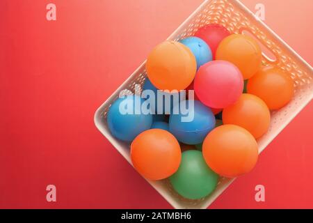 Close up of multi color ball on red background Stock Photo