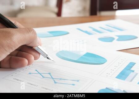 Close up of man hand analyzing chart on paper Stock Photo