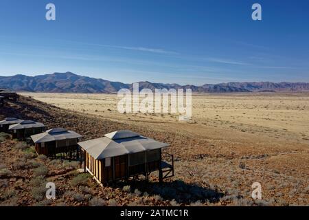 A martian landscape, typical tourist accommodation high on stilts in the desert, Namibia, Africa. Stock Photo