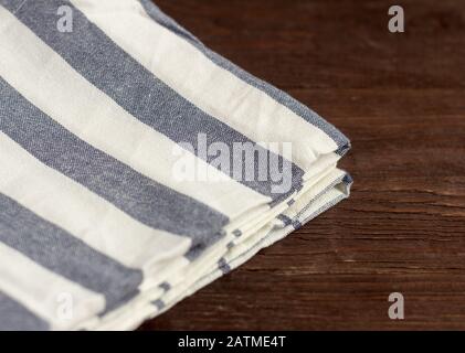 Kitchen striped linen napkin on an old wooden background Stock Photo