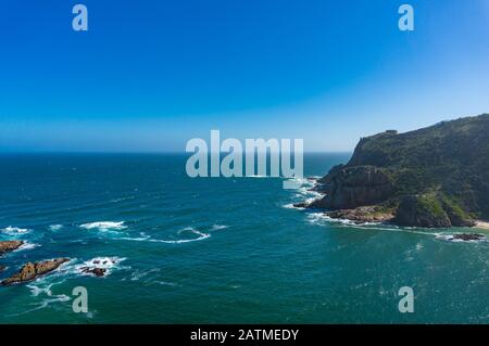 Seascape with open ocean view and coastal hills and cliffs. Coastline near Knysna on Garden Route in South Africa Stock Photo