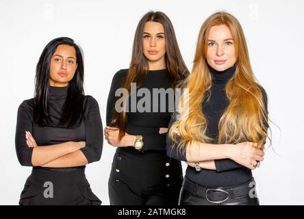three young female friends pose together in the Studio. women employees of a beauty salon Stock Photo