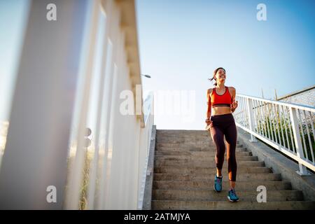 Happy young woman exercising outdoors. Living healthy life Stock Photo