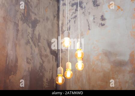 Modern Edison light bulbs. Vintage style light bulbs. Many different vintage light bulbs hanging from ceiling. Loft pendant lamps Stock Photo