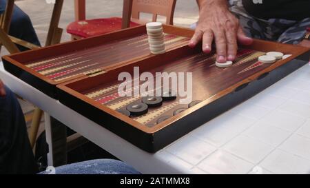 Aged retired men playing backgammon in the outside. board games enjoyment. Stock Photo