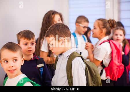 School children in uniform with backpacks going to class Stock Photo