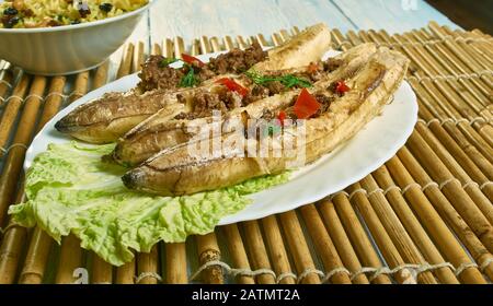 Puerto Rican  Stuffed Baked Plantains, roasted plantains filled with seasoned ground meat, tomatoes, onions, bell pepper, and spices Stock Photo