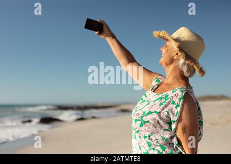 Old woman taking selfies at the beach Stock Photo - Alamy