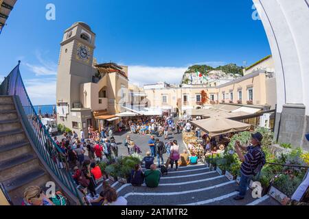 People at Piazza Umberto I Square with Church of Santo Stefano in old town of Capri Island town, Italy. Landscape at Italian coast. Spherical view. Stock Photo