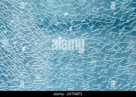 Cracked and damaged glass window for texture and background Stock Photo