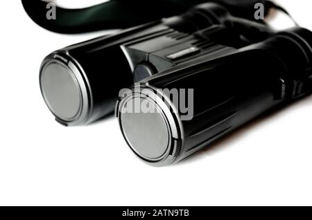 Black binoculars with closed lenses rests on a white background Stock Photo