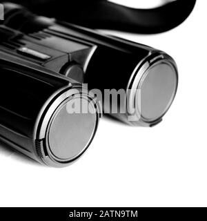 Black binoculars with closed lenses rests on a white background Stock Photo