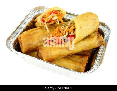 Chinese crispy vegetable filled spring rolls in an aluminium foil take away tray isolated on a white background Stock Photo
