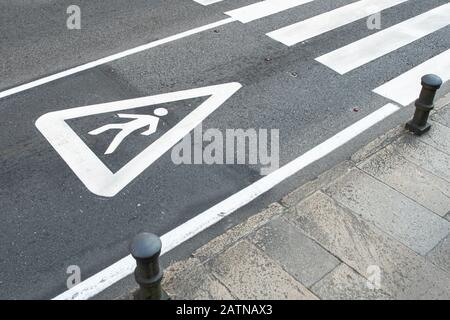 Pedestrian sign painted on the asphalt of a city road. Zebra crossing concept Stock Photo