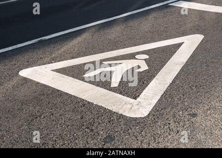 Pedestrian sign painted on the asphalt of a city road. Zebra crossing concept Stock Photo