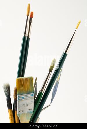 Artistic art supply utensils with paintbrushes isolated on white background with selective focus Stock Photo
