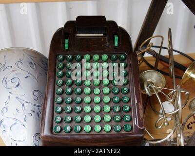 Vintage adding machine and a bunch of junk sold at a flea market Stock Photo