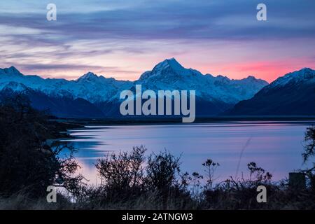 Beautiful colorful sunrise over glacial Lake Pukaki and Mount Cook from near Twizel, winter, New Zealand Stock Photo