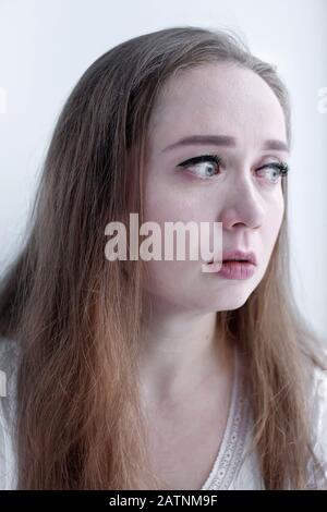 Expressive close-up portrait of crying woman with tears running on her face, beautiful upset emotional woman Stock Photo