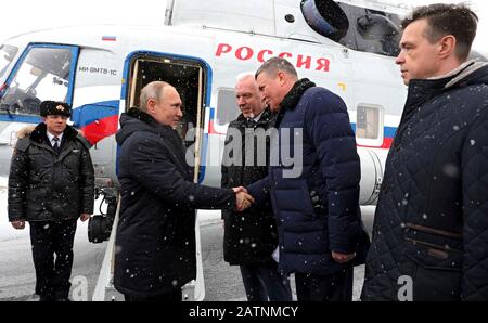 Cherepovets, Russia. 04th Feb, 2020. Russian President Vladimir Putin, left, is greeted by Vologda Region Governor Oleg Kuvshinnikov and Northwestern Federal District Presidential Envoy Alexander Gutsan upon his arrival on a snowy day at Cherepovets International Airport February 4, 2020 in Cherepovets, Russia. Credit: Michael Klimentyev/Kremlin Pool/Alamy Live News Stock Photo