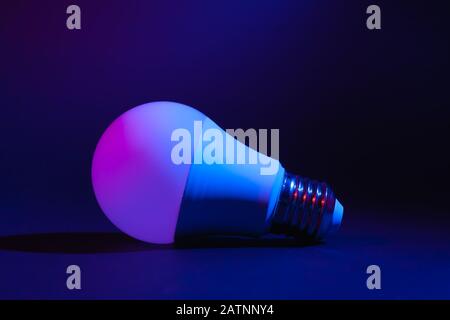 Smart LED lamp, economical and durable with the ability to adjust color and brightness. Stock photo of a tech ice lamp. Stock Photo