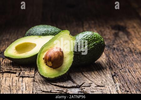 Fresh avocado on rustic wooden table - Close up Stock Photo