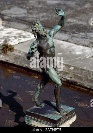 Italy, Pompeii. House of the Faun. Dancing Faun. Impluvium in the Atrium. Copy (the original sculpture is preserved in the Archaeological Museum of Naples). Stock Photo