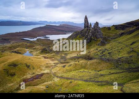 The famous Old Man of Storr in Skye is just formidable. The silhouette of the two persons in the middle of image shows the magnitude of the rocks. Stock Photo