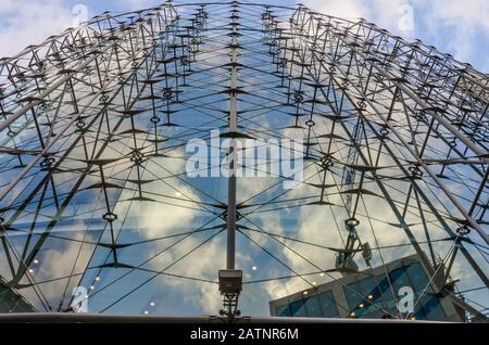 A low angle view of a modern of a modern glass building. Stock Photo